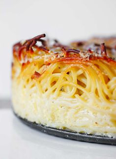 a close up of a plate of food with noodles and sauce on it's surface