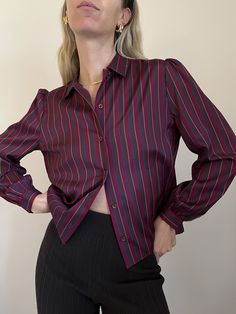 "Vintage 70s Berry-tones Blouse   Fabulous femme blouse in a variety of the colors of the season. Beautiful, billowy, lightweight fabric in a great berry-tones color palette with a pop of blue. Ruched detailing at top shoulders, so chic. Femme button up silhouette with a dainty collar and button front. Single button closure at each cuff. Billowy balloon-like sleeves.  Excellent condition.  Dress this up or down through the seasons.    Color: Berry tones / Blue  Material: 100% polyester  Recommended Fit: S-M depending on desired fit Size Tag Reads: 12 Measures approximately (laid flat)-  Shoulder to shoulder-  16\" Pit to pit- 21\" Shoulder to hem length-  21\" Styled on height 5'9\" / size S (4)   Please know all pieces are vintage and may show signs of pre-loved wear.  We do our best to n Romance Core, Berry Tones, Vintage Feminine, Stripe Blouse, Fashion Forecasting, Blouse Vintage, Striped Blouse, Merlot, Modern Fashion