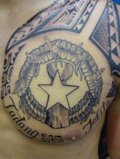 a man with a tattoo on his chest has a star and wreath in the middle