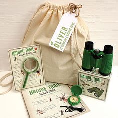 the contents of a nature trail binoculars and other items are shown in front of a bag