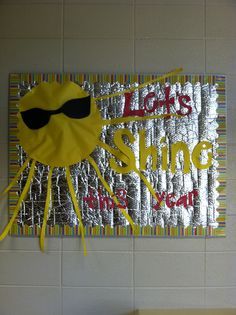 a room with two beds and a wall hanging on the wall that has an image of a yellow monster wearing sunglasses