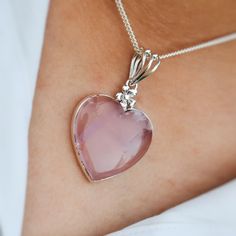 This beautiful heart pendant has a natural rose quartz in the center that shines with the light, making it the perfect Christmas and valentine gift for someone special in your life. Made with 925 solid sterling silver, this pendant boasts its beauty with every move. sterling silver heart pendant is a beautiful Christmas and valentine gift. The natural rose quartz is known as the stone of protection, love, forgiveness and compassion. It's also said to bring hope, devotion and good luck.  It is a Feminine Sterling Silver Necklaces For Gifts, Pink Gemstone Heart Necklace Gift, Silver Heart Shaped Feminine Necklace, Pink Gemstone Heart Necklace For Gift, Pink Heart Gemstone Necklace For Gift, Silver Heart Necklace Feminine Style, Feminine Silver Heart Necklace, Feminine Heart Necklace As A Valentine's Day Gift, Feminine Heart Necklace For Valentine's Day Gift