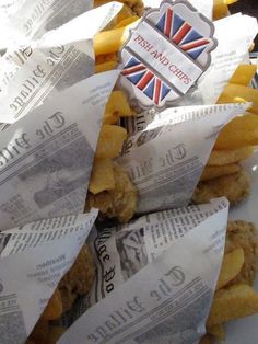 some food is sitting on top of newspaper paper and has a british flag sticker