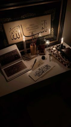 a desk with some writing and candles on it