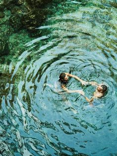 two people are swimming in the water together