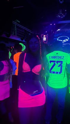 two women in neon outfits standing next to each other