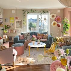 a living room filled with lots of furniture and flowers