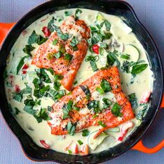 two salmon fillets are in a skillet