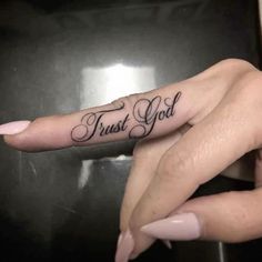 two hands with tattoos that say, trust god