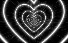 two hearts in the middle of a black and white background with light streaks around them