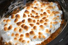 a crock pot filled with marshmallows and cream