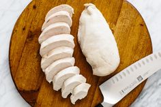 sliced chicken on a cutting board with a knife