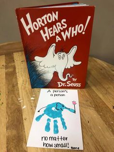 the book horton hears who by dr seuss sits on a table next to a handprint