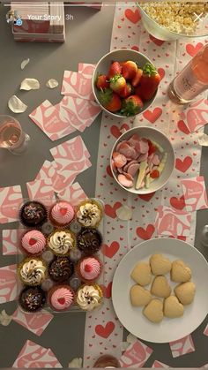 a table topped with lots of different types of desserts and pastries next to wine glasses