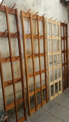 several wooden shelves lined up against a wall