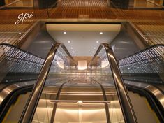 an escalator in a building with glass railings