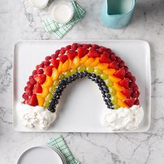 a cake shaped like a rainbow on a plate