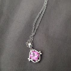 A Silver Chain And Silver Pendant With A Pink Gemstone Of Some Kind. Possibly Glass. Silver Gemstone Charm Necklace For Her, Sterling Silver Gemstone Charm Necklace Fine Jewelry, Fine Jewelry Sterling Silver Gemstone Charm Necklace, Fine Jewelry Sterling Silver Charm Necklace With Gemstone, Silver Cubic Zirconia Square Pendant Jewelry, Silver Cubic Zirconia Jewelry With Square Pendant, Sterling Silver Jewelry With Square Pendant And Adjustable Chain, Sterling Silver Square Pendant With Adjustable Chain, Sterling Silver Jewelry With Adjustable Square Pendant