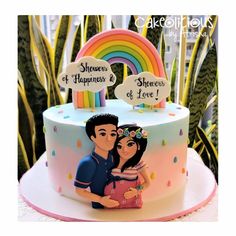 a cake with a couple on it and a rainbow sign in the top corner that says, shower of happiness & sherbers of love