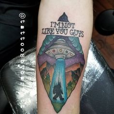 a tattoo with the words i'm not like you guys on it, and an alien