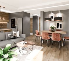 a modern living room and dining area with wood flooring, grey couches and chairs