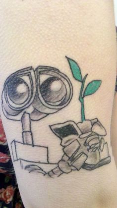 a tattoo on the leg of a person with a plant and binoculars