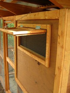 the inside of a chicken coop with wooden walls