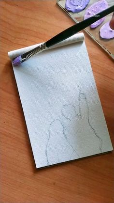 a person is drawing on a piece of paper