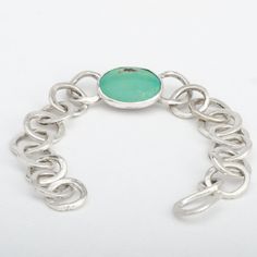 The "Laredo" Turquoise bracelet is handmade from 925 sterling silver (92.5% pure silver) in my workshop. It features a beautiful Natural Green Turquoise gemstone. Green Turquoise cabochon. Weight: 6.04 ct. Size: 19.75x16.01x2.51 mm Each link of the bracelet has been hand formed separately. Each link is soldered to the next one to form a finished bracelet. The whole bracelet is then polished by hand. The bracelet attaches with a handmade sterling silver hook clasp. Being hand formed, each link is Turquoise Sterling Silver Bracelet, Artisan Turquoise Sterling Silver Bracelet, Handmade Turquoise Sterling Silver Oval Bracelet, Handmade Turquoise Oval Sterling Silver Bracelet, Handmade Oval Turquoise Sterling Silver Bracelet, Silver Turquoise Jewelry, Unique Bracelets, Green Turquoise, Turquoise Gemstone