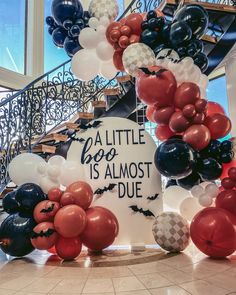 balloons are arranged around a sign that says, a little boo is almost duee