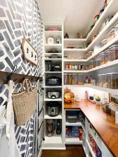 an organized pantry with lots of shelves and baskets on the counter top, along with other items