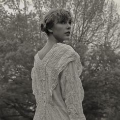 black and white photograph of a woman in an old fashioned dress looking off to the side