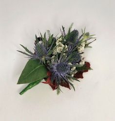 a bouquet of flowers on a white surface