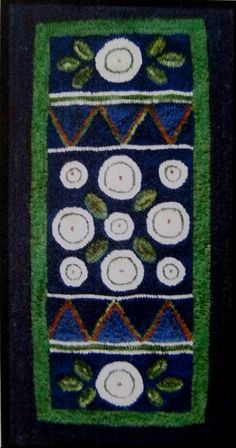 a blue and green rug with white circles on it