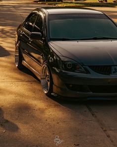 a black car is parked on the side of the road