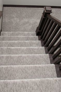 the stairs are made of wood and carpet