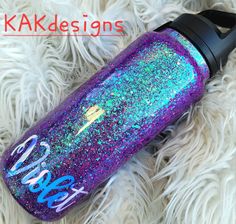 a purple and blue glittered water bottle with the words kaka designs on it