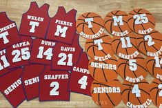 several basketballs with numbers on them sitting next to each other in front of a wooden table