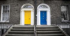 two blue and yellow doors are in front of a brick building