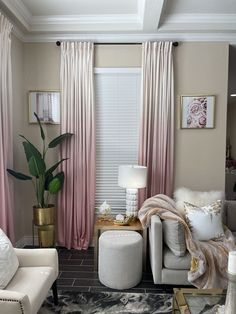 a living room filled with furniture and pink curtains