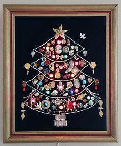 a christmas tree made out of buttons on a black background with gold trimmings