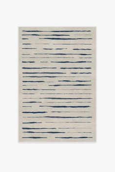 a white and blue rug with lines on it