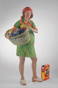 a woman holding a basket full of clothes