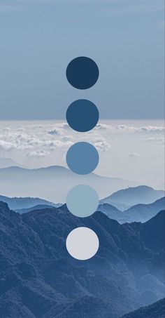 the sky is filled with blue and white circles in front of some mountains under a cloudy sky