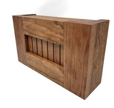 a wooden box that is made out of wood and has bars on the front side