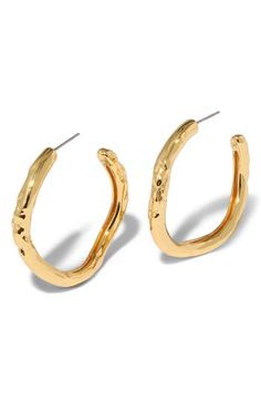 These modern hoop earrings feature a molten, sculptural silhouette that catch the light from every angle. 1 1/2" drop; 1/4" width Post back 14k-gold plate or sterling silver plate Imported Contemporary Gold Hoop Earring, Modern Hammered Drop Hoop Earrings, Modern Gold Hammered Hoop Earrings, Modern Textured Gold Hoop Earrings, Contemporary Small Hoop Gold Earrings, Modern Textured Small Hoop Earrings, Modern Hoop Earrings, Tube Hoop Earrings, Platform Slippers