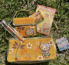 hello kitty pencils, book and pen case in the grass