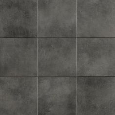 a gray tile wall with different shades of grey