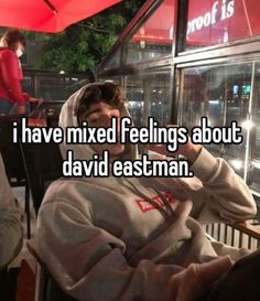 a person sitting in a chair with the caption i have mixed feelings about david eastman