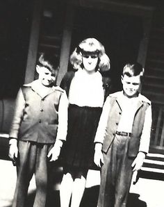 an old black and white photo of three children